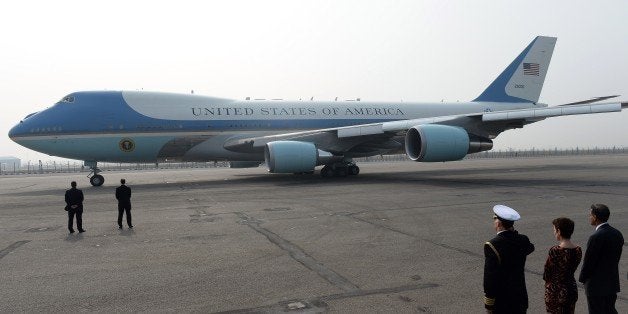 The US embassy defence attache salutes as the Air Force One aircraft prepares to taxi with US President Barack Obama and his wife Michelle Obama on board at Palam Air Force station in the Indian capital New Delhi on January 27, 2015. President Barack Obama said the United States could be India's 'best partner' January 27 as he wrapped up a three-day visit to New Delhi by highlighting the shared values of the world's biggest democracies. AFP PHOTO / PRAKASH SINGH (Photo credit should read PRAKASH SINGH/AFP/Getty Images)