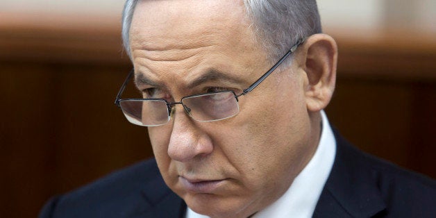 Israeli Prime Minister Benjamin Netanyahu listens during in his Cabinet meeting in his office in Jerusalem on Sunday, Nov. 23