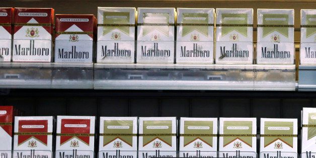 FILE - In this Oct. 23, 2013, file photo, varieties of Marlboro cigarettes appear on display at a store in Little Rock, Ark. Altria, maker of Marlboro and other cigarette brands, reports quarterly financial results on Friday, Jan. 30, 2015. (AP Photo/Danny Johnston, File)