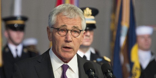 Departing US Secretary of Defense Chuck Hagel delivers remarks at his Armed Forces Farewell Ceremony at Joint Base Fort Myer-Henderson in Arlington, Virginia, January 28, 2015. AFP PHOTO / JIM WATSON (Photo credit should read JIM WATSON/AFP/Getty Images)