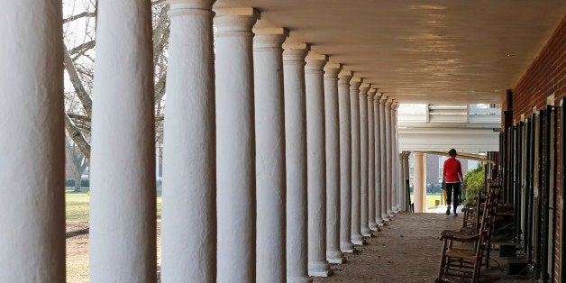 A student walks along the lawn at the University of Virginia in Charlottesville, Va., Monday, Nov. 24, 2014. (AP Photo/Steve Helber)