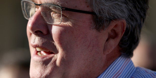 MIAMI, FL - DECEMBER 17: Former Florida Governor Jeb Bush hands out items for Holiday Food Baskets to those in need outside