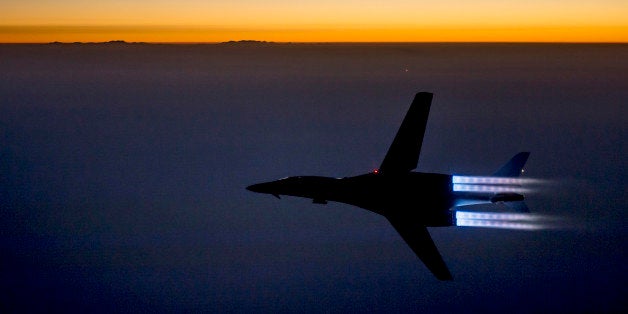 In this Saturday, Sept. 27 photo released by the U.S. Air Force, a fighter jet flies over northern Iraq after conducting airs