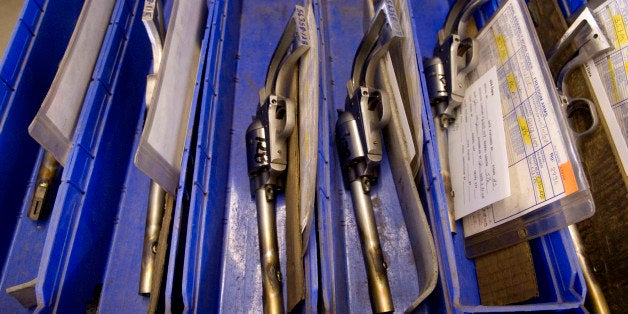 FILE - This April 2008 file photo of Model 83 revolvers ready to be test fired sitting in a bin during manufacturing at Freed