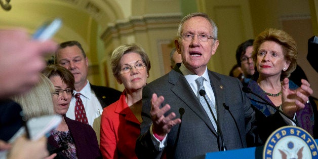 Senate Majority Leader Harry Reid, a Democrat from Nevada, speaks during a news conference with fellow Senate Democrats, from left, Senator Amy Klochubar from Minnesota, Senator Jon Tester from Montana, Senator Elizabeth Warren from Massachusetts, and Senator Debbie Stabenow from Michigan, following a private meeting at the U.S. Capitol Building in Washington, D.C., U.S., on Thursday, Nov. 13, 2014. U.S. Senate Democrats plan to elevate first-term Massachusetts Senator Elizabeth Warren to their leadership ranks on an expanded communications and policy committee led by third-ranking Democrat Charles Schumer. Photographer: Andrew Harrer/Bloomberg via Getty Images