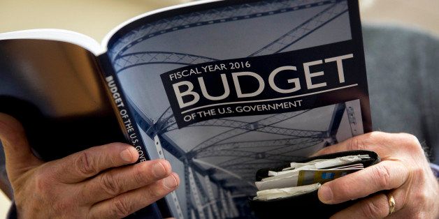 Customer Jeff Simering reads copies of U.S. President Barack Obama's Fiscal Year 2016 Budget while waiting in line to purchase the books at the U.S. Government Publishing Office (GPO) in Washington, D.C., U.S., on Monday, Feb. 2, 2015. Obama sent Congress a $4 trillion budget that would raise taxes on corporations and the nation's top earners, spend more on infrastructure and housing, and stabilize, but not eliminate, the annual budget deficit. Photographer: Andrew Harrer/Bloomberg via Getty Images 