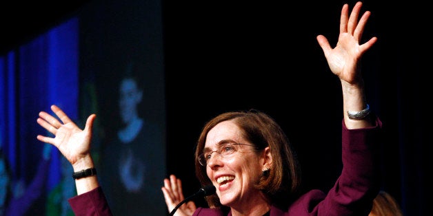 Oregon Democratic Secretary of State Kate Brown celebrates at the podium after winning her race at Democratic headquarters in Portland, Ore., Tuesday, Nov. 6, 2012.(AP Photo/Don Ryan)