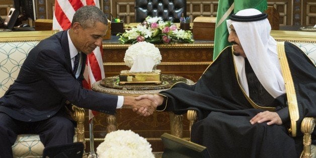 Saudi's newly appointed King Salman (R) shakes hands with US President Barack Obama at Erga Palace in Riyadh on January 27, 2