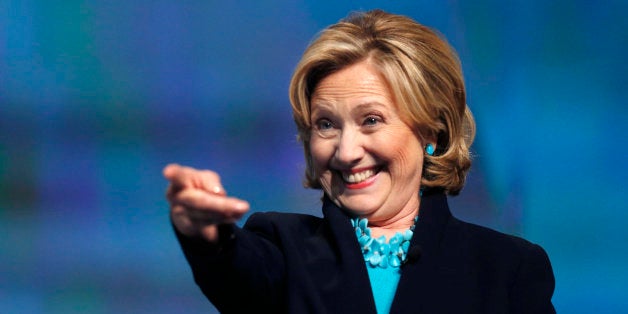 Former Secretary of State Hillary Rodham Clinton reacts as she is introduced to speak at the Massachusetts Conference for Women in Boston, Thursday, Dec. 4, 2014. (AP Photo/Elise Amendola)