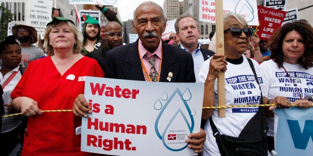 DETROIT, MI - JULY 18 : Congressman John Conyers, Jr., (D-Mich.) clinches his fist as he joins demonstrators protesting against the Detroit Water and Sewer Department July 18, 2014 in Detroit, Michigan. The Detroit Water and Sewer Department have disconnected water to thousands of Detroit residents who are delinquent with their bills. (Photo by Joshua Lott/Getty Images)