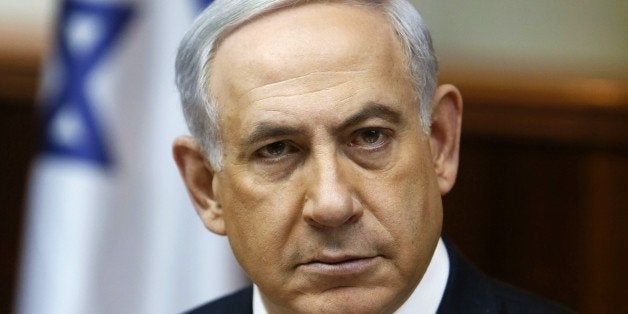 Israeli Prime Minister Benjamin Netanyahu looks on as he opens the weekly cabinet meeting at his Jerusalem office on February