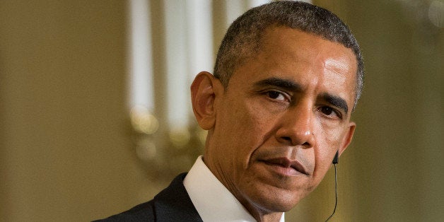 In this photo taken Feb. 9, 2015, President Barack Obama listens in the East Room of the White House in Washington. The presi