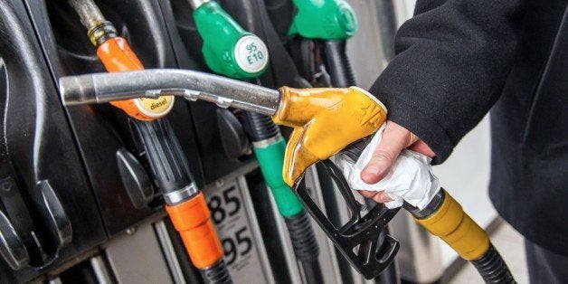 A motorist uses a pump at a petrol station on the A25 motorway near Godewaersvelde, northern France, on January 16, 2015. Oil