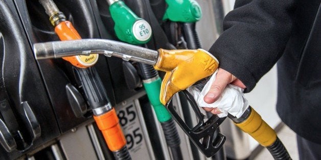 A motorist uses a pump at a petrol station on the A25 motorway near Godewaersvelde, northern France, on January 16, 2015. Oil plunged close to six-year lows this week on oversupply worries, before staging a slight recovery as the International Energy Agency declared there were signs that 'the tide will turn'. AFP PHOTO / PHILIPPE HUGUEN (Photo credit should read PHILIPPE HUGUEN/AFP/Getty Images)