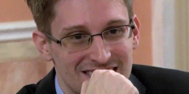 In this image made from video released by WikiLeaks on Friday, Oct. 11, 2013, former National Security Agency systems analyst Edward Snowden smiles during a presentation ceremony for the Sam Adams Award in Moscow, Russia. Snowden was awarded the Sam Adams Award, according to videos released by the organization WikiLeaks. The award ceremony was attended by three previous recipients. Snowden, who is charged by a U.S. court with violating the Espionage Act for disclosing the classified NSA programs, has been granted asylum in Russia. (AP Photo)