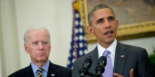 U.S. President Barack Obama delivers a statement on legislation he sent to Congress to authorize the use of military force (AUMF) against the Islamic State with U.S. Vice President Joseph 'Joe' Biden, left, in the Roosevelt Room of the White House in Washington, D.C., U.S., on Wednesday, Feb. 11, 2015. Obama formally asked Congress to authorize military action against Islamic State, saying the extremist group has committed 'despicable acts of violence' and would threaten the U.S. if not confronted. Photographer: Andrew Harrer/Bloomberg via Getty Images 