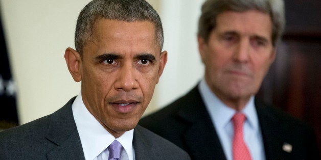 U.S. President Barack Obama, delivers a statement on legislation he sent to Congress to authorize the use of military force (AUMF) against the Islamic State with John Kerry, U.S. secretary of state, right, in the Roosevelt Room of the White House in Washington, D.C., U.S., on Wednesday, Feb. 11, 2015. Obama formally asked Congress to authorize military action against Islamic State, saying the extremist group has committed 'despicable acts of violence' and would threaten the U.S. if not confronted. Photographer: Andrew Harrer/Bloomberg via Getty Images 