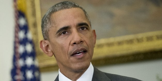 U.S. President Barack Obama delivers a statement on legislation he sent to Congress to authorize the use of military force (AUMF) against the Islamic State with U.S. Vice President Joseph 'Joe' Biden, left, in the Roosevelt Room of the White House in Washington, D.C., U.S., on Wednesday, Feb. 11, 2015. Obama formally asked Congress to authorize military action against Islamic State, saying the extremist group has committed 'despicable acts of violence' and would threaten the U.S. if not confronted. Photographer: Andrew Harrer/Bloomberg via Getty Images 