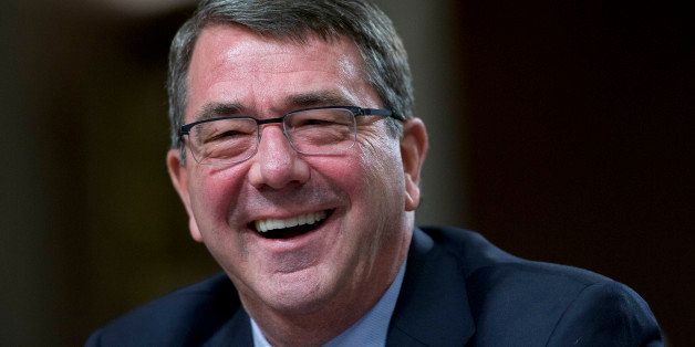 Ashton Carter, former deputy secretary of defense and U.S. President Barack Obama's nominee to be U.S. secretary of defense, laughs during a Senate Armed Services Committee nomination hearing in Washington, D.C., U.S., on Wednesday, Feb. 4, 2015. Carter pledged to stop cost overruns and other wasteful spending, even as he pleaded for relief from automatic budget cuts that will resume in October. 