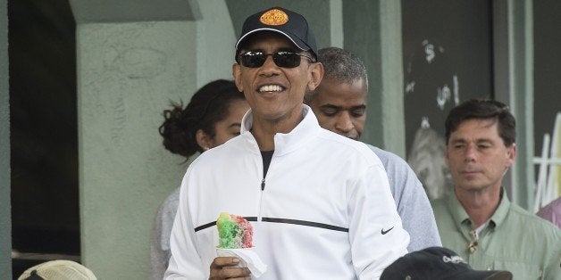 US Prdesident Barack Obama has shave ice with friends at Island Snow in Kailua on January 1, 2015. AFP PHOTO/NICHOLAS KAMM (Photo credit should read NICHOLAS KAMM/AFP/Getty Images)