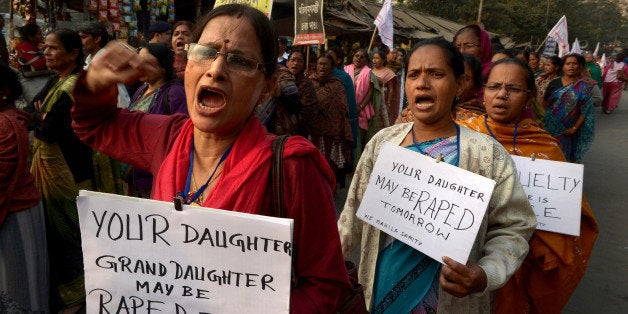 Leftist women activists carry posters as they shout slogans during a protest march against the gangrape and murder of a teenager, in Kolkata on January 3, 2014. An Indian teenager near the eastern city of Kolkata has been gangraped twice and then burned alive, police said, sparking protests after she died of her injuries. The 16-year-old was assaulted first on October 26, 2013 and then again the day after by a group of more than six men near her family's home in Madhyagram town, about 25 kilometres (15 miles) north of Kolkata. After being set on fire on December 23, she died in a state-run hospital on December 31. AFP PHOTO/Dibyangshu SARKAR (Photo credit should read DIBYANGSHU SARKAR/AFP/Getty Images)