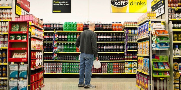 A customer shops in the soda aisle of a Dollar General Corp. store in Saddle Brook, New Jersey, U.S., on Saturday, Dec. 3, 2011. Dollar General is scheduled to announce earnings results on Dec. 5. Photographer: Emile Wamsteker/Bloomberg via Getty Images