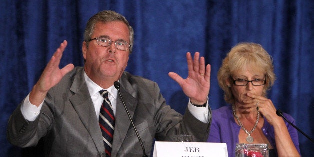 Former Florida governor Jeb Bush, left, makes a point as Kathleen Oropeza, the Orlando mother who helped create the Fund Education Now group, listens during the Florida Forward education reform forum, hosted by the Orlando Sentinel, Tuesday, September 20, 2011, in downtown Orlando, Florida. (Joe Burbank/Orlando Sentinel/MCT via Getty Images)