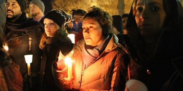 WASHINGTON, UNITED STATES - FEBRUARY 12: People hold a vigil at Dupont Circle in Washington on February 12, 2015 for three Muslim students who were shot dead in Chapel Hill, North Carolina. Muslim students Deah Barakat, 23, his wife Yusor Mohammad Abu-Salha, 21, and her sister Razan Mohammad Abu-Salha, 19, were shot dead at their home on Tuesday in Chapel Hill, North Carolina. (Photo by Muhammed Bilal Kenasari/Anadolu Agency/Getty Images)