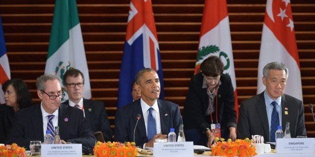 US President Barack Obama speaks (C) during a meeting with leaders from the Trans-Pacific Partnership at the US Embassy in Beijing on November 10, 2014 in Beijing. From left: US Trade Representative Mike Froman, Obama, and Singapore Prime Minister Lee Hsien Loong. Top leaders and ministers of the 21-member APEC grouping are meeting in Beijing from November 7 to 11. AFP PHOTO/Mandel NGAN (Photo credit should read MANDEL NGAN/AFP/Getty Images)