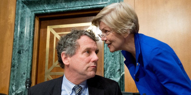 WASHINGTON, DC - JANUARY 27: Ranking Member Sen. Sherrod Brown (D-Ohio), left, speaks with Sen. Elizabeth Warren (D-Mass.), right, during a Senate Banking, Housing and Urban Affairs Committee hearing on Capitol Hill on January 27, 2015 in Washington, DC. (Photo by Andrew Harnik for The Washington Post via Getty Images)