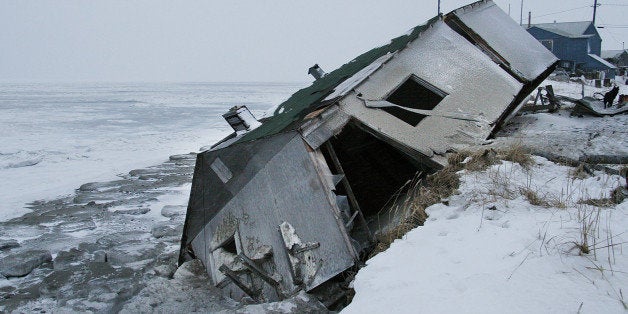 ** ADVANCE FOR TUESDAY, DEC. 26 **Nathan Weyiouanna's abandoned house at the west end of Shishmaref, Alaska, Dec. 8, 2006, sits on the beach after sliding off during a fall storm in 2005. Like some other Alaska villages, the Inupiat Eskimo community of 600 is facing an expensive relocation because of erosion, which is eating away at the current site on a narrow island just north of the Bering Strait. (AP Photo/Diana Haecker)