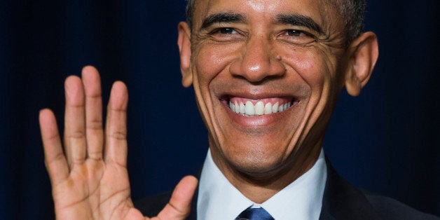 President Barack Obama waves to the Dalai Lama as he was recognized during the National Prayer Breakfast in Washington, Thursday, Feb. 5, 2015. The annual event brings together U.S. and international leaders from different parties and religions for an hour devoted to faith. (AP Photo/Evan Vucci)