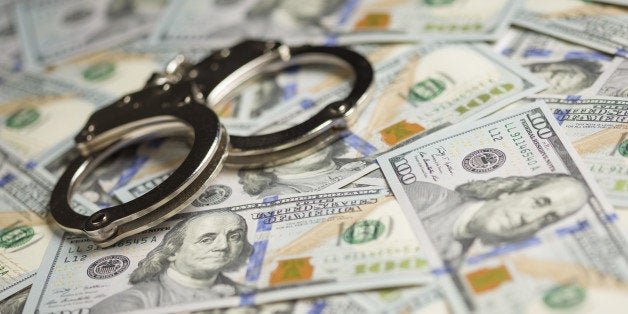 Handcuffs Laying on Newly Designed U.S. One Hundred Dollar Bills.