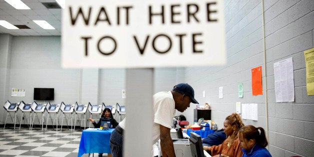 In this May 16, 2014 photo, Charles Poole, 70, checks in upon arriving to cast his ballot at a polling site during early voting for Georgia's upcoming May 20 primary election in Atlanta. Fulton County officials are promising efficiency at the polls during Tuesday's primary, despite a lingering inquiry by the Georgia Secretary of State and Attorney General into ballot and voting problems during the 2010 and 2012 elections. (AP Photo/David Goldman)