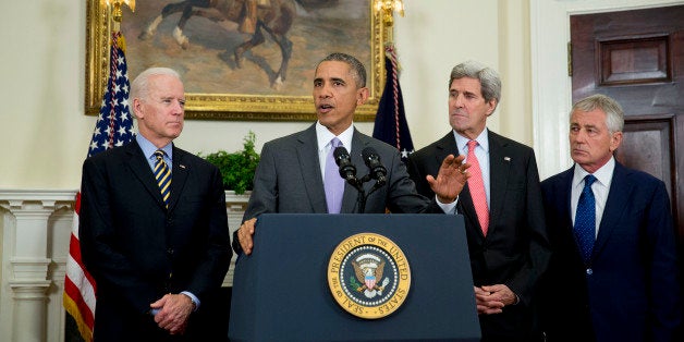 U.S. President Barack Obama, second from left, delivers a statement on legislation he sent to Congress to authorize the use of military force (AUMF) against the Islamic State with U.S. Vice President Joseph 'Joe' Biden, from left, Obama, John Kerry, U.S. secretary of state, and Chuck Hagel, outgoing U.S. secretary of defense, in the Roosevelt Room of the White House in Washington, D.C., U.S., on Wednesday, Feb. 11, 2015. Obama formally asked Congress to authorize military action against Islamic State, saying the extremist group has committed 'despicable acts of violence' and would threaten the U.S. if not confronted. Photographer: Andrew Harrer/Bloomberg via Getty Images 