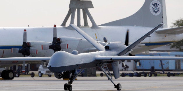 FILE - In this Nov. 8, 2011 file photo, a Predator B unmanned aircraft taxis at the Naval Air Station in Corpus Christi, Texas. Missiles from U.S. drones slammed into militant hideouts overnight in northwestern Pakistan, killing more than a dozen of suspected insurgents and marking the resumption of the CIA-led program after a nearly six-month break, officials said Thursday, June 12, 2014. (AP Photo/Eric Gay, File)