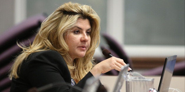 FILE - In this June 3, 2013, file photo, Nevada Assemblywoman Michele Fiore, R-Las Vegas, works in committee during the final day of the 77th Legislative session at the Legislative Building in Carson City, Nev. Taxation Committee Chairwoman Michele Fiore broke her weeklong silence about dozens of tax liens filed against her and her companies, saying an unnamed employee who stole from her and systematically deceived her accountant was at the root of the problem. Fiore, a sophomore Republican lawmaker and Assembly majority leader, told conservative radio host Alan Stock on Tuesday, Dec. 16, 2014, that she has addressed the issue. She also argued that her experience working with the IRS though the resolution process is a reason she should retain her leadership on the tax committee. (AP Photo/Cathleen Allison, File)