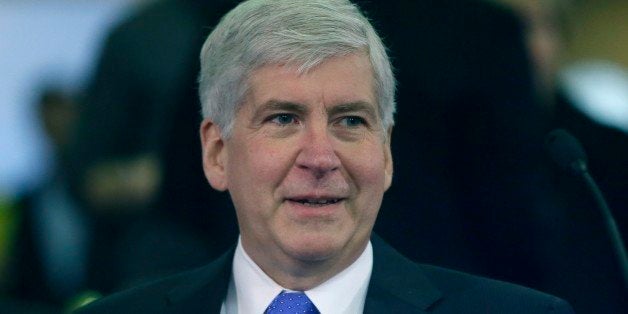 Michigan Gov. Rick Snyder is seen before proposing his state budget, Wednesday, Feb. 11, 2015 in Lansing, Mich. The governor proposed a $54 billion state budget that he said prioritizes education and health services, including focus on improved reading for third graders, more training in the skilled trades and increased dental coverage for low-income children. The Republican governor's plan for the fiscal year starting in October would increase spending by roughly $2 billion, or 3.8 percent, mostly because of higher federal funding. (AP Photo/Carlos Osorio)