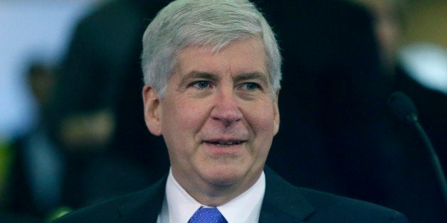 Michigan Gov. Rick Snyder is seen before proposing his state budget, Wednesday, Feb. 11, 2015 in Lansing, Mich. The governor proposed a $54 billion state budget that he said prioritizes education and health services, including focus on improved reading for third graders, more training in the skilled trades and increased dental coverage for low-income children. The Republican governor's plan for the fiscal year starting in October would increase spending by roughly $2 billion, or 3.8 percent, mostly because of higher federal funding. (AP Photo/Carlos Osorio)