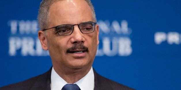 Attorney General Eric Holder speaks at the National Press Club in Washington, Tuesday, Feb. 17, 2015. The Obama administration put its new deportation relief program on hold on the eve of enactment Tuesday, complying reluctantly with a federal judgeâs order blocking it that roiled immigrant communities nationwide and seemed to harden a tense stalemate on Capitol Hill. Holder said the Justice Department was still in the process of looking at the opinion and deciding what steps to take. (AP Photo/Manuel Balce Ceneta)