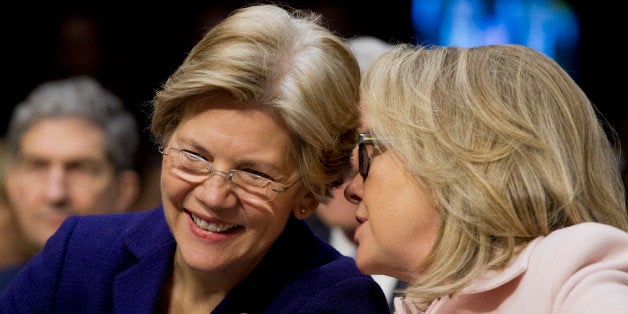 Senator Elizabeth Warren, a Democrat from Massachusetts, left, and U.S. Secretary of State Hillary Clinton talk during a Senate Foreign Relations Committee nomination hearing in Washington, D.C., U.S., on Thursday, Jan. 24, 2013. Senator John Kerry stressed the need to prevent Iran from acquiring nuclear weapons. He described the 'immediate, dangerous challenges' facing the nation as he seeks confirmation to become secretary of state. Photographer: Andrew Harrer/Bloomberg via Getty Images 