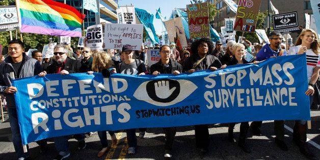 Demonstrators march outside of the U.S. Capitol in Washington during a rally to demand that the U.S. Congress investigate the National Security Agency's mass surveillance programs Saturday, Oct. 26, 2013. ( AP Photo/Jose Luis Magana)