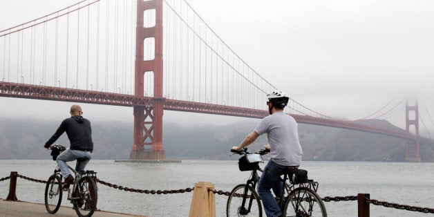 Bicyclists ride to the Golden Gate Bridge in San Francisco, Wednesday, Aug. 3, 2011. Golden Gate Bridge officials have skirted a smashup over proposed bicycle speed limits by putting up new signs and creating separate lanes across the famous span to keep the peace between pedestrians and cyclists forced to share the bridge's one remaining open sidewalk. Beginning this week, the new signs on lamp posts and yellow road striping split the east sidewalk into one lane for pedestrians and another for bikers. (AP Photo/Paul Sakuma)