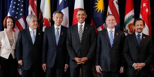 President Barack Obama, third right, stands with Prime Minister Julia Gillard of Australia, left, President Sebastian Pinera of Chile, second left, Prime Minister Lee Hsien Loong of Singapore, third left, Prime Minister John Key of New Zealand, second right, and Sultan Hassanal Bolkiah of Brunei, right, as they take part in the Trans-Pacific Partnership meeting at the APEC summit in Yokohama, Japan, Sunday, Nov. 14, 2010. (AP Photo/Charles Dharapak)