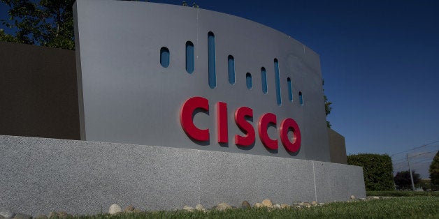 Cisco Systems Inc. signage stands at the company's headquarters in San Jose, California, U.S., on Friday, Aug. 15, 2014. Cisco Systems Inc. Chief Executive Officer John Chambers is struggling to revamp the world's largest networking-equipment maker, eliminating 6,000 jobs in a new round of cuts and forecasting little to no sales growth. Photographer: David Paul Morris/Bloomberg via Getty Images