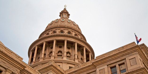 An angular view of the Italian Renaissance Revival architecture, the Texas Capitol, features the Sunset Red granite of this imposing building