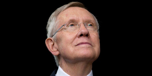 Senate Majority Leader Harry Reid of Nev., looks to President Barack Obama as he speaks about immigration at Del Sol High School, in Las Vegas, Friday, Nov. 21, 2014. The president unveiled expansive executive actions on immigration Thursday night to spare nearly 5 million people in the U.S. illegally from deportation, setting off a fierce fight with Republicans over the limits of presidential powers. (AP Photo/Carolyn Kaster)