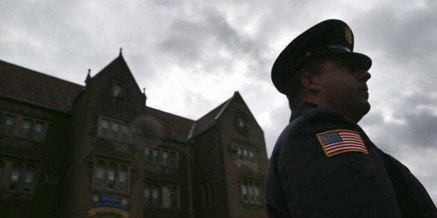 WALLKILL, NY - NOVEMBER 24: A prison guard stands at the entrance of the Wallkill Correctional Facility in Ulster County on November 24, 2014 in Wallkill, New York. Archbishop of New York, Cardinal Timothy Dolan, celebrated a pre-Thanksging Mass in the prison chapel, and the service was attended by some 30 inmates as well as staff of the medium-security prison. The facility houses a total of almost 600 prisoners, most of them from New York City. (Photo by John Moore/Getty Images)