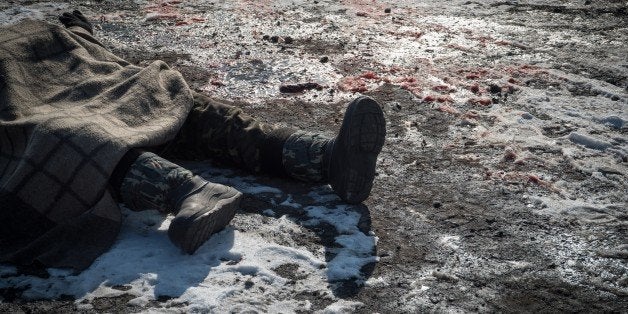 A picture shows a body of a Ukrainian serviceman in the eastern Ukrainian city of Debaltseve on February 20, 2015. Germany and France demanded that a crumbling Ukraine truce be 'fully respected' even as pro-Russian rebels celebrated a battlefield victory in a strategic town and exchanged artillery fire elsewhere with government troops.AFP PHOTO/ ANDREY BORODULIN (Photo credit should read ANDREY BORODULIN/AFP/Getty Images)