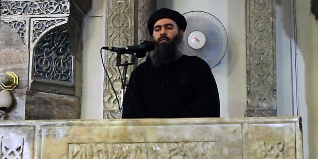 MOSUL, IRAQ - JULY 5 : An image grab taken from a video released on July 5, 2014 by Al-Furqan Media shows alleged Islamic State of Iraq and the Levant (ISIL) leader Abu Bakr al-Baghdadi preaching during Friday prayer at a mosque in Mosul.(Photo by Al-Furqan Media/Anadolu Agency/Getty Images)